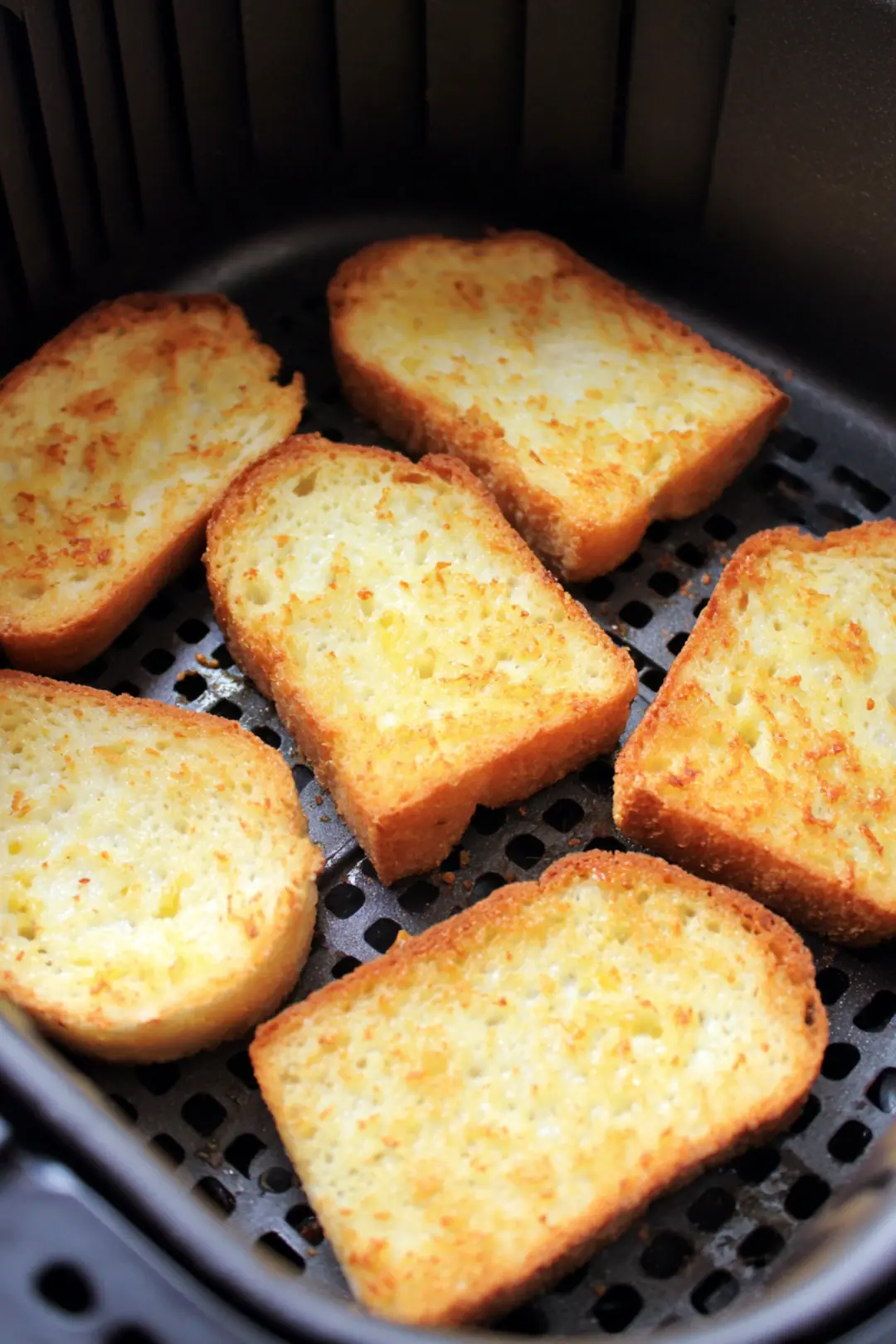 Place the bread slices coated in custard in the air fryer basket and cook until golden brown