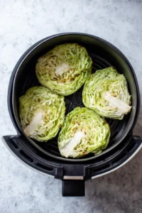 Place the cabbage steaks in the air fryer basket in a single layer