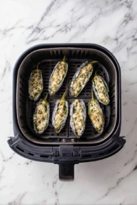 Place the filled and wrapped jalapenos in the air fryer