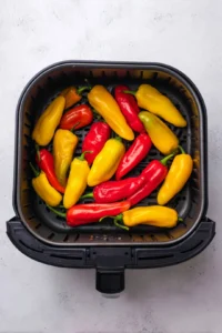 Place the peppers in the air fryer basket in a single layer
