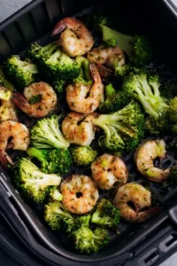 Place the shrimp and broccoli in the air fryer basket and cook for 10 minutes, shaking halfway through the cooking time. Serve immediately!