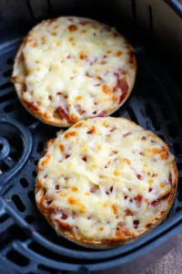 Place topped English muffins in the air fryer
