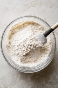 Portion the batter into small bite-sized rounds and place in the air fryer basket
