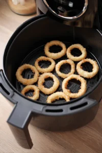 Preheat your air fryer to 375°F (190°C). Place the coated onion rings in a single layer in the fryer basket and cook for about 10 minutes, flipping halfway through, until golden brown and crispy.