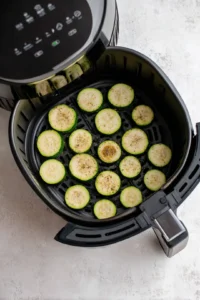 Preheat air fryer and slice zucchini