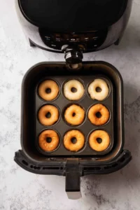 Preheat air fryer to 350 degrees Fahrenheit and fill donut molds
