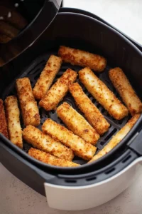 Preheat the air fryer to 200°C and arrange the halloumi fries in a single layer
