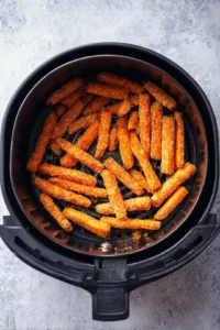 Preheat the air fryer to 375 degrees Fahrenheit and arrange the coated carrots evenly in the basket