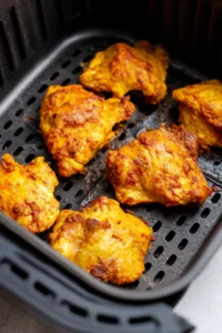 Preheat the air fryer to 380°F and cook marinated chicken thighs for 25 minutes