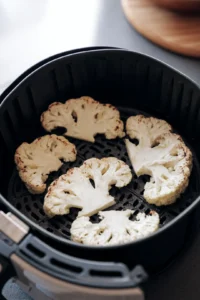 Preheat the air fryer to 400 degrees Fahrenheit and prepare cauliflower steaks
