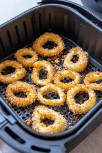 Preheat your air fryer to 400°F and arrange breaded calamari rings