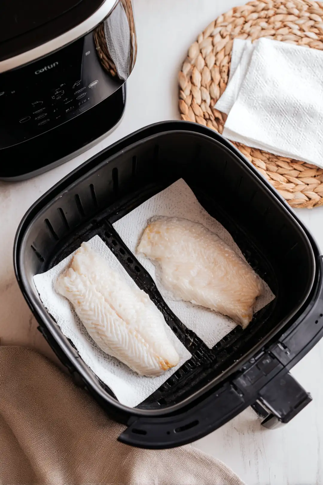 Preheat your air fryer to 400°F (200°C) and dry the trout fillets