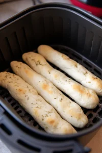 Prepare air fryer breadsticks with seasoning and cheese