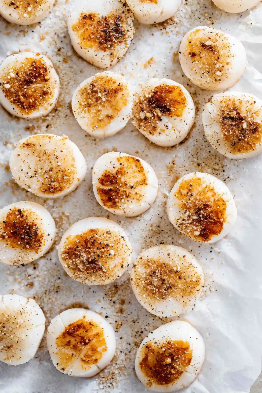 Season scallops with salt and pepper