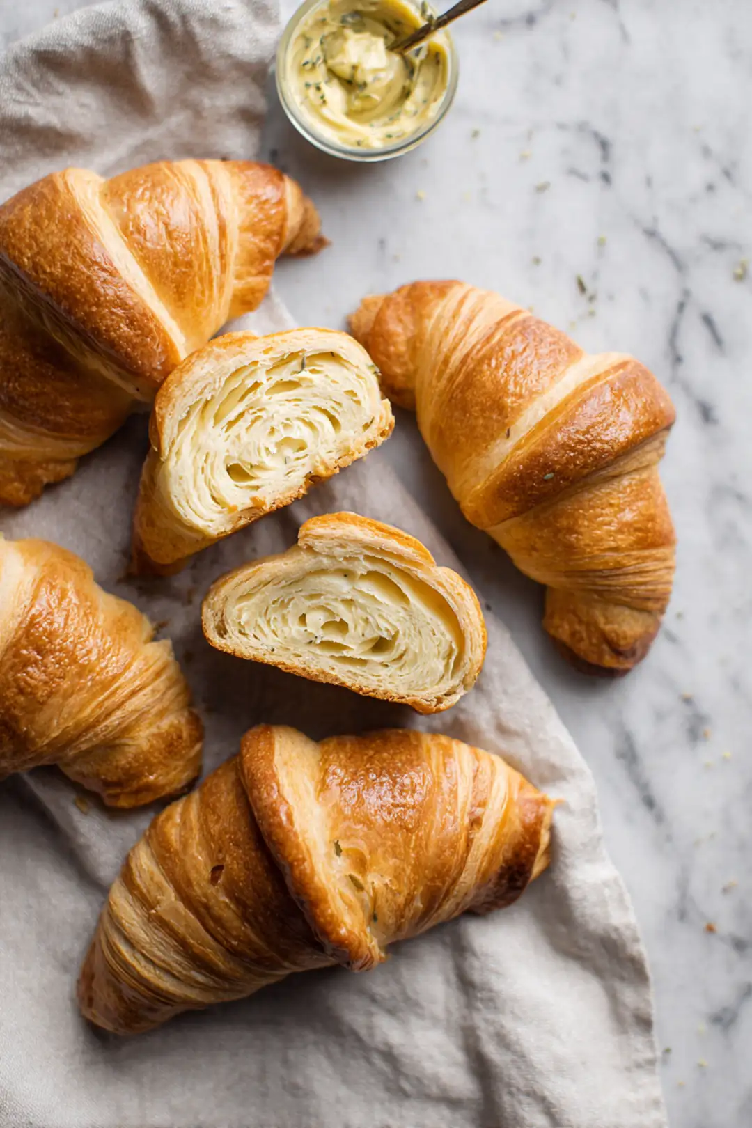 Spread mustard on sliced croissants