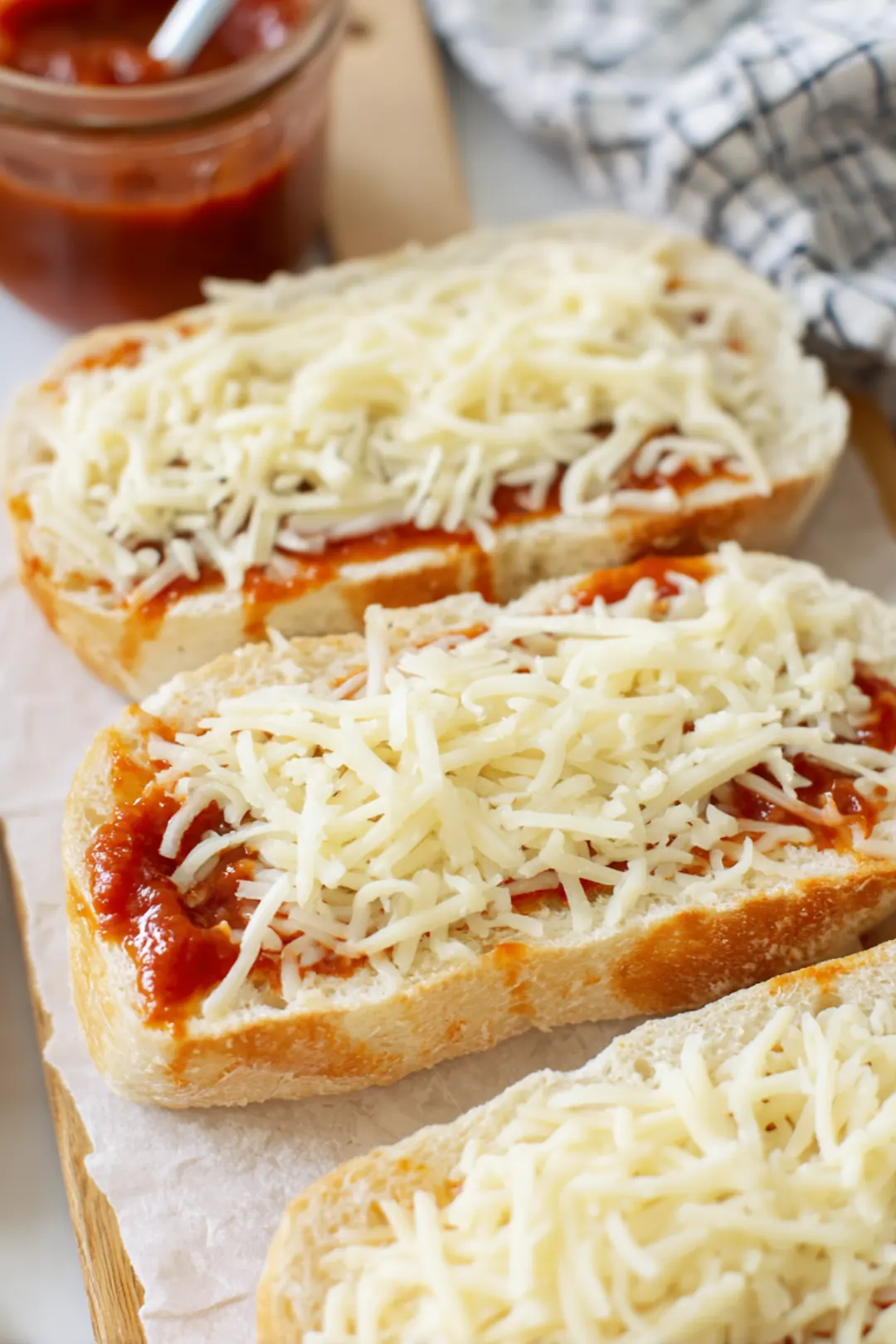 Spread pizza sauce and mozzarella cheese on bread