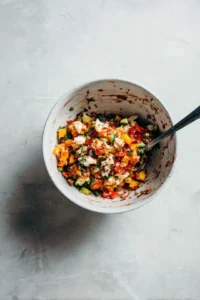 Stir in the cheese, chopped vegetables, and seasonings, mixing until everything is evenly distributed.