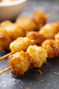 Thread frozen tater tots onto skewers