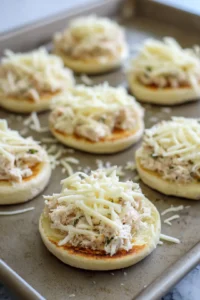Top English muffin halves with tuna mixture and cheese