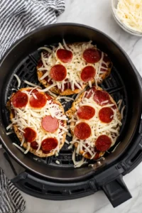 Top the chicken with shredded mozzarella and pepperoni slices