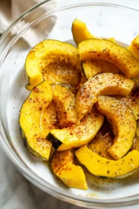 Toss acorn squash slices with olive oil and spices