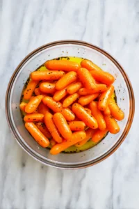 Toss baby carrots with olive oil, maple syrup, salt, and black pepper