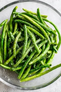 Toss fresh green beans with olive oil, salt, and black pepper