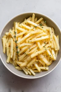 Toss parsnip sticks with olive oil, thyme, salt, and pepper