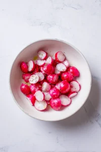 Toss radishes with olive oil, salt, and pepper until evenly coated