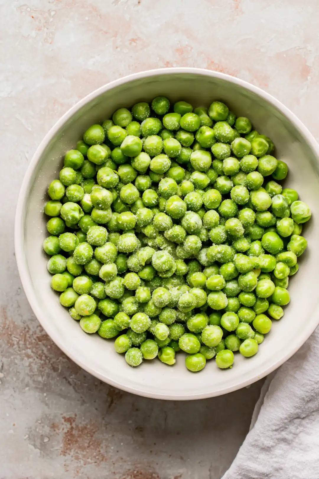 Toss the peas with olive oil, garlic powder, salt, and black pepper
