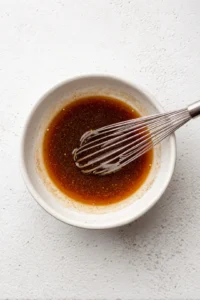 Whisk together honey, soy sauce, and garlic powder in a bowl