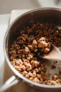 Add ground turkey to the pot and cook until browned
