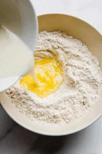 Add milk and melted butter to the dry ingredients