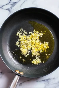 Add minced garlic and sauté until fragrant