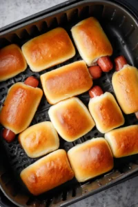 Add mini hot dogs to buns in air fryer