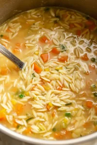 Add orzo, chicken broth, and diced vegetables to the bowl and stir to combine