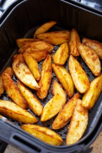 Add potato wedges to the air fryer and cook until golden brown