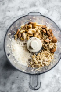 Add the nuts, grated parmesan, and a pinch of salt and pepper