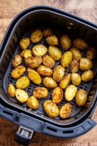 Air fry the potato wedges until crispy