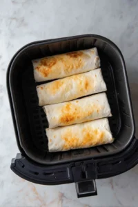 Arrange burritos in air fryer basket