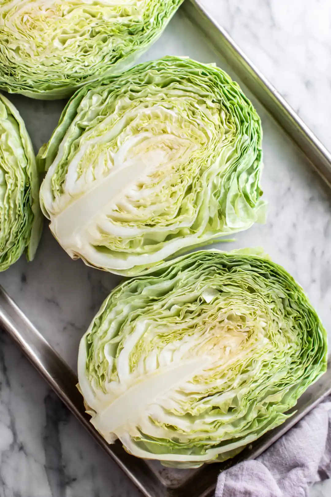 Arrange cut green cabbage steaks on a baking sheet