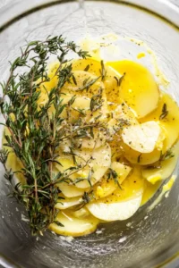Arrange the potato slices in a spiral shape to form a rose