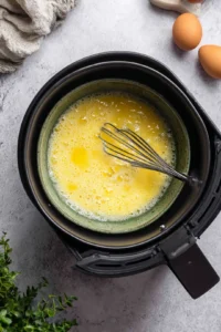 Assemble rice paper wraps with bacon, scrambled eggs, and shredded cheese