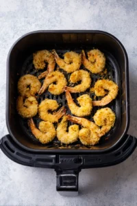 Assemble sandwiches with cooked shrimp, lettuce, tomato, and remoulade sauce