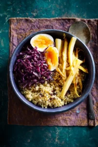 Assemble the power bowls with quinoa, pickled cabbage, and steamed parsnips