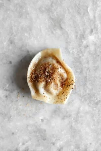 Brush wonton wrapper with water and seasoning, then place in air fryer