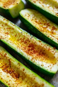 Brush zucchini halves with olive oil and season them