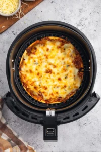 Carefully place the prepared tortillas in the air fryer basket and cook for 8 minutes, or until the cheese is bubbly and the edges are crispy. Remove and let cool for a minute before slicing.