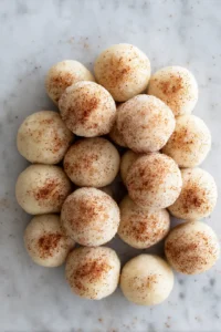Coat dough balls in cinnamon-sugar and place in air fryer basket