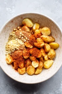 Coat heart-shaped potatoes with olive oil and spices